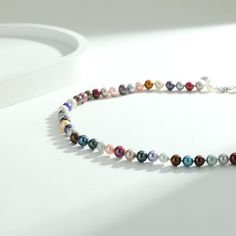 Add a splash of color to your day with our Adjustable Multicolored Pearl Necklace. This piece features nearly round pearls in a spectrum of colors, strung together with an adjustable extension chain. It's a versatile and vibrant accessory that can adapt to any neckline or outfit. Length: 18" inches with an extension chain of 2" inches, perfect for women. (45cm - 51cm) Product Information Pearl Type Freshwater Origin China Shape Nearly Round Quality AA+ Size 6-7mm Nacre Very Thick Color Colored M Multicolor Beaded Necklace With Pearl Charm, Multicolor Beaded Necklace With Pearl Pendant, Elegant Multicolor Pearl Chain Necklace, Multicolor Pearl Necklace With Colorful Beads, Multicolor Round Beads Pearl Necklace, Multicolor Pearl Charm Necklaces, Multicolor Pearl Charm Necklace, Multicolor Pearl Necklaces With Pearl Charm, Multicolor Single Strand Round Pearl Necklace