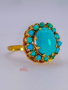 Get ready to fall in love with this exquisite Antique Sleeping Beauty Turquoise Halo 18K Gold Ring! With its captivating design and stunning craftsmanship, this ring is a true gem. Let's delve into the details: Style: Antique Halo flower setting Materials: 18K Gold Ring Size: 6.75 Hallmarks: Unmarked Condition: Good (G) Description: The item exhibits moderate wear but remains in generally good condition. Surface may show visible scratches or wear, though not detracting from the overall appearance. Metals may have a more noticeable patina or signs of gentle aging. Gemstones may have slight abrasions or wear, still retaining their luster.  Specifications: * Primary Stone(s) Type: Turquoise * Primary Stone(s) Shape: Round Cabochon, Oval Cabochon * Primary Stone(s) Dimensions: 2.00 - 9.75 × 7. Luxury Turquoise 14k Gold Ring, Luxury Blue Turquoise Ring For Wedding, Luxury Yellow Gold Turquoise Cabochon Ring, Luxury Turquoise Cabochon Ring In Yellow Gold, Luxury Turquoise Round Ring, Antique Turquoise Ring In Yellow Gold, Formal Turquoise Multi-stone Rings, Luxury Yellow Gold Turquoise Ring For Formal Occasions, Luxury Multi-stone Turquoise Round Ring