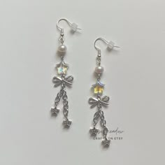 "Handmade Beaded Earrings ✿ Made with glass beads, freshwater pearls, and metal accents ✿ Silver, iridescent clear, and pearlescent white ✿ The earrings are 3.1\"  Fish Hook Options ✿ The Titanium fish hook is hypoallergenic and ideal for sensitive skin ✿ The regular fish hook is made of nickel free metal, it is not hypoallergenic" Silver Beaded Pearl Earrings For Party, Nickel-free White Crystal Metal Earrings, Silver Pearl Beaded Earrings For Party, Nickel-free White Metal Crystal Earrings, White Metal Dangle Crystal Earrings, Silver Pearl Drop Beaded Earrings, Silver Beaded Pearl Earrings, White Pearl Crystal Earrings For Pierced Ears, White Pearl Crystal Earrings