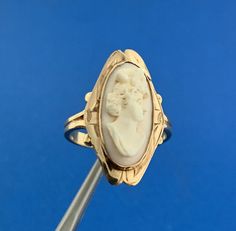 * Gorgeous 14k Yellow Gold White Cameo Shell Womens Bust Finger Ring Size 7 * Metal: 14k Yellow Gold * Ring Size: 7 * Top of Ring Measurements: 1" x 5/8" * Band Width: 2.53 mm * Weight: 2.9 tgw * Condition: As pictured. * G2749 5% Restocking Fee    Exported By ExportYourStore :) Victorian Yellow Gold Rings With Polished Finish, Yellow Gold Intaglio Jewelry, Victorian White Gold Rings With Polished Finish, 14k Yellow Gold Cabochon Ring, White Gold Cabochon 14k Gold Rings, White Gold Cabochon Rings 14k, White Gold Cabochon Rings In 14k Gold, 14k White Gold Cabochon Rings, Victorian Style Polished White Gold Ring