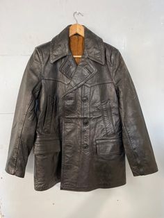 "Stunning blk leather pea coat . Ex military / police . Storm cuffs  Padded shoulder s S ..M depending on required  fit.... see.   measurements  Size says 44\"(incorrect)  Pit to pit 20\"(40\") Length 35\" Shoulder to Shoulder 17\" Shoulder to cuff 25\" Condition is great  Some fade on leather collar & sleeve .. see pics  1 internal pocket  leather is heavy & very hard wearing  Beautiful item" Winter Military Leather Outerwear, Black Double-breasted Military Outerwear, Vintage Winter Biker Jacket With Flap Pockets, Vintage Winter Biker Jacket With Snap Buttons, Military Leather Jacket For Fall, Vintage Biker Jacket With Flap Pockets For Winter, Military Style Leather Jacket For Fall, Vintage Biker Jacket With Snap Buttons For Winter, Vintage Black Leather Jacket With Button Closure