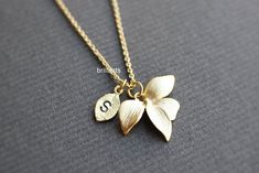 Personalized Orchid flower pendant necklace.▶▶ You can make this necklace personal choosing the quantity of letter leaf from option.And please leave a note for the desired letters in 'Add your personalization' section.▶ Material - Gold, Rose gold, and Rhodium (silver color) plated over brass▶ Chain Length - 16 ~ 18 inches (custom length available)▶ Pendant measure - Orchid H. 15mm x W. 21mm, Leaf H. 11mm x W. 6mm▶ The matching earrings availablehttps://www.etsy.com/listing/190937422/orchid-flowe Flower Charm Jewelry For Wedding Gift, Wedding Gift Jewelry With Flower Charm, Elegant Bridesmaid Gift Necklace, Elegant Birth Flower Necklaces For Bridesmaids, Personalized Flower-shaped Necklaces For Wedding, Personalized Flower-shaped Necklace For Wedding, Delicate Personalized Necklaces For Wedding Gift, Elegant Flower Shaped Necklace For Personalized Gift, Delicate Necklaces For Wedding And Gifts