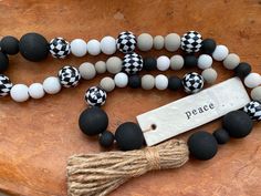 a black and white beaded necklace with a tassel