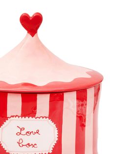 a red and white striped container with a heart on top