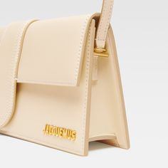 The long Bambino in ivory is the perfect accessory for anyone looking to make a statement. Crafted from luxurious calf leather with tonal stitching, this bag exudes sophistication and style. The detachable shoulder strap adds versatility, while the gold-tone logo lettering adds a touch of elegance. With a spacious main compartment and internal pockets, this bag is both practical and fashionable. Elevate any outfit with the Bambino in Orange! Jacquemus Le Bambino Long, Long Shoulder Bag, Neon Bag, Backpack Travel Bag, Black Shoulder Bag, Mini Handbags, Mini Wallet, Wallet Bag, Metallic Logo