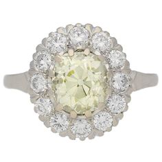 Fancy light yellow diamond cluster ring, circa 1950. | From a unique collection of vintage cluster rings at https://www.1stdibs.com/jewelry/rings/cluster-rings/ Vintage Diamond White Platinum Halo Ring, Vintage Platinum Cluster Diamond Ring, Vintage Cluster Ring With Halo Design, Vintage Platinum Halo Ring In Diamond White, Vintage White Gold Halo Ring With Brilliant Cut, Vintage Platinum Halo Ring With Brilliant Cut, Vintage Diamond Ring With Halo Design For Anniversary, Vintage Diamond White Halo Ring, Vintage White Halo Ring With Prong Setting