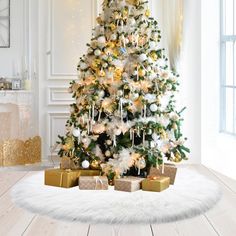 a white christmas tree with presents under it