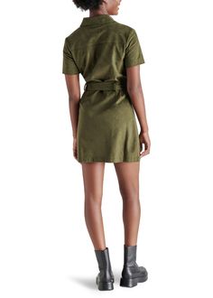 Experience the feel of luxurious faux suede in the Steve Madden Jolene Dress. This olive green mini dress features a tie at the waist, providing a sleek silhouette perfect for any occasion—from a girls night out to holiday festivities. Elevate your look with knee-high boots for a stylish fall look. Fit: True to Size Model is wearing a size S Imitation Leather: 100% Polyurethane Button closure all the way down If you would like to see more photos or speak with one of our stylists with any further Faux Suede Fabric, Leather Mini Dress, Loungewear Jumpsuit, Green Mini Dress, Midi Maxi Dress, Plus Size Swimwear, Shirtdress, Long Blouse, Fall Looks