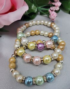 This handmade pearl and crystal glass bead bracelet is comprised of High Quality Glass White and Light Gold (Ivory) Crystallized Pearls, 8mm Birthstone Colored Glass Crystal Pearls, silvertone plated Crystal Rondelle Spacers. The bracelet pictured is a size 7.25" and is made with strong, durable, quality stretch cord for comfortable and easy wear. This will be shipped in a gift sash bag or gift box and a bubble envelope.  **Please remember sales tax is collected by Etsy depending upon your location and will be added at checkout...thank you! Thanks for stopping by and have a great day! Colors may vary depend upon your screen divice/monitor. This product is intended for adult use only.  CHOKING HAZARD WARNING: This jewelry is Not intended for young children.  Babies and young children may ch Silver Beaded Pearl Stretch Bracelet, Pearl Crystal Bracelet With Faceted Round Beads, Silver Pearl Bracelet With Colorful Beads, Pearl Beaded Stretch Bracelet, Elegant Pearl Bracelet With Colorful Beads, Pearl White Beaded Stretch Bracelet, Elegant Multicolor Pearl Beaded Bracelets, Elegant Multicolor Beaded Pearl Bracelet, Silver Pearl Beaded Bracelets With Colorful Beads