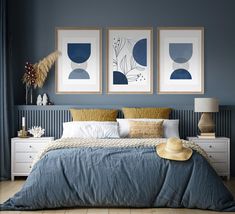 a bedroom with blue walls and two pictures on the wall above the bed, along with a straw hat