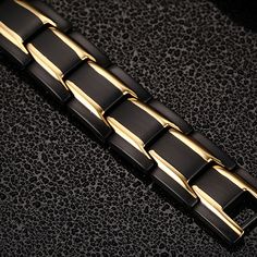 Subtle details make this men's bracelet a great choice for him! Weight: 49.8 gWidth: 12 mmMaterial: Titanium SteelBracelet Size: 22 mmStone Type: Jeulia® StonePlating Color: Black, Yellow Gold Masculine Black Stainless Steel Bracelets, Black Magnetic Metal Bracelets, Men's Wedding Bands, Men's Bracelet, Mens Wedding Bands, Italian Charm Bracelet, Mens Bracelet, Bespoke, Wedding Bands