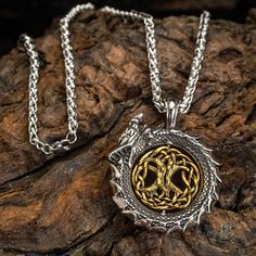 This stunning necklace is going to be a real head turner! Featuring Jormungand, Serpent of Midgard as the main feature, with a rotating Yggdrasil (Tree of Life) in its center as a support act. This will definitely get you noticed! Available in a choice of two chain lengths: 50cm (approx. 19.5") and 70cm (approx. 27.5") Viking Style Metal Pendant Jewelry, Dragon Design Amulet Necklace, Spiritual Dragon Design Pendant Jewelry, Viking Style Metal Necklace For Gift, Viking Style Engraved Metal Necklaces, Fantasy Metal Necklaces For Collectors, Fantasy Metal Pendant Necklace, Viking Style Silver Round Pendant Necklace, Symbolic Dragon Design Round Pendant Necklace