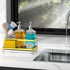 a kitchen sink with soap, toothbrushes and other bathroom items in the holder