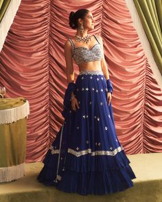 Make a stunning impression in this electric blue embellished blouse, beautifully paired with a lehenga featuring cancan for added volume and flair. The matching dupatta adds a graceful touch, creating an enchanting ensemble perfect for weddings and festive celebrations, ensuring you shine brightly on any special occasion. Cut Blouse, Vacuum Storage, Embroidered Lehenga, Indian Wedding Wear, Lehenga Blouse, Embroidered Dupatta, Embellished Blouse, Sleeves Blouse, Silk Lehenga