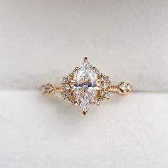 an engagement ring with a pear shaped diamond in the center