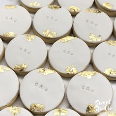 white and gold decorated cookies on a table