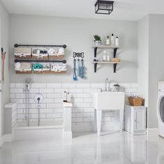 the bathroom is clean and ready to be used as a washer, dryer, and toilet