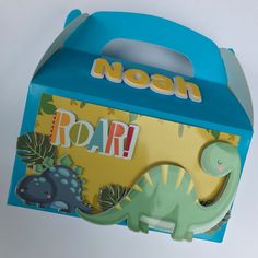 a blue box with an image of a dinosaur on the front and word roar in the middle