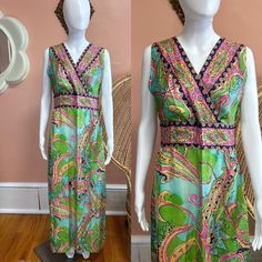 "Vibrant 70s handmade maxi dress. Dress has a colorful paisley/abstract print made up of pinks, blues and greens. The front is a criss cross top that cinches at the waist. Zips in back. Condition: Excellent/good - some light faded spots in dress but they do not detract from this beautiful dress! Measurements (approx.+ laid flat): Shoulder to shoulder:15.5\" Pit to pit:18\" Waist:16\" Hips:23\" Total length:54\" Follow us on IG for more shop updates @modern_m_vintage Check out our other listings: Fitted Lined Maxi Dress, Green V-neck Paisley Print Dress, Green V-neck Dress With Paisley Print, Bohemian Floral Print Dress With Empire Waist, Retro V-neck Dress With Vibrant Print, Vibrant Print Fitted Long Dress, Summer V-neck Vintage Print Dresses, Bohemian V-neck Dress With Vintage Print, Retro V-neck Lined Maxi Dress