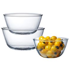 three clear bowls filled with oranges on top of each other in front of a white background