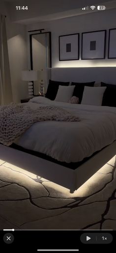 a large bed sitting in a bedroom next to two lamps on either side of it