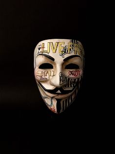 a person wearing a mask with words written all over it and the word live on it