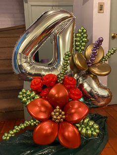 the number six is made out of balloons and flowers