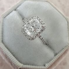 a cushion cut diamond ring in a velvet box