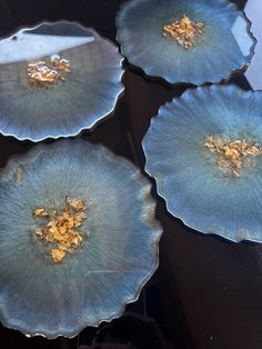 three blue plates with gold flowers on them