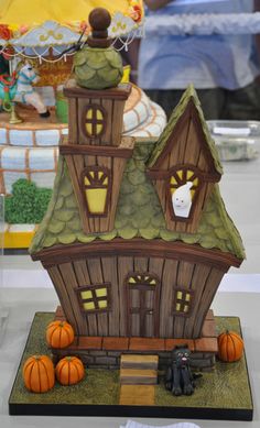 a halloween themed house with pumpkins on the table