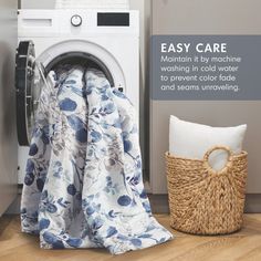 a washer and dryer sitting next to each other in front of a laundry basket