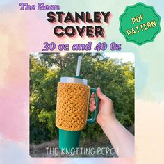 a hand holding a coffee cup in front of a colorful background with the words stanley cover 30 o'clock and 40 o'o'clock