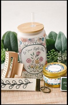 a jar with a wooden lid sitting on top of a table next to other items