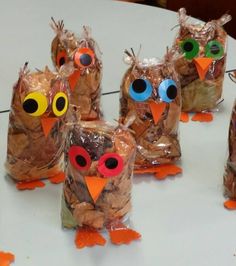 several plastic bags filled with food shaped like owls sitting on top of a white table