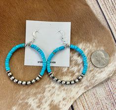 Make a statement with these stunning Turquoise Beaded Hoop Earrings. Crafted from sterling silver and finished with a Navajo Pearl accent, they're the perfect way to add a luxurious touch to your look. Add Turquoise Beaded Hoop Earrings to your jewelry collection today! Embrace the Southwest's allure with Native American Turquoise Sterling Silver Hoop earrings – a timeless addition to elevate your style for any occasion. Size: 2" inches wide x 2 3/4" inches length Stone: Turquoise with Navajo Pe Turquoise Southwestern Hoop Earrings, Turquoise Earrings With Silver Beads, Southwestern Turquoise Hoop Earrings Nickel Free, Turquoise Southwestern Nickel-free Hoop Earrings, Southwestern Turquoise Nickel-free Hoop Earrings, Turquoise Nickel-free Small Hoop Beaded Earrings, Deodorant Stains, Native American Turquoise, American Turquoise