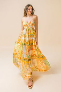 A printed maxi dress featuring plunging V neckline, side cut-out and a tiered skirt. Details Self: 100% Polyester Lining: 100% Polyester Size & Fit - Model is 5`8" And Wearing Size Small - Measurements Taken From Size Small - Approx. Length: 51" Yellow Printed Maxi Dress For Party, Chic Yellow Floor-length Dresses, Yellow Printed V-neck Maxi Dress, Yellow Floor-length Maxi Dress For Spring, Yellow V-neck Maxi Dress For Vacation, Printed Yellow Maxi Dress, Yellow Beach Maxi Dress, Chic Yellow Flowy Maxi Dress, Chic Flowy Yellow Maxi Dress