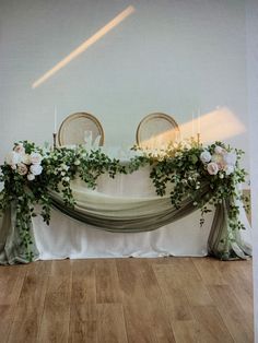 the table is decorated with flowers and greenery for an elegant wedding ceremony or reception