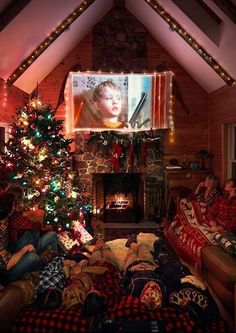 a living room filled with furniture and a christmas tree in front of a flat screen tv