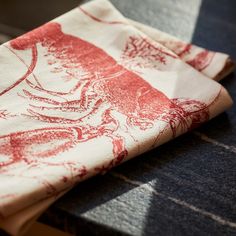 a red and white napkin sitting on top of a table