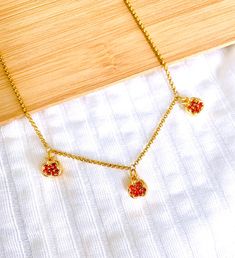 Elegant nature-inspired necklace representing pomegranates. - The pomegranate charms are gold-plated with red zirconia crystals for a glimmering shine and vibrance - Suitable for long-term use and everyday wear thanks to the stainless steel chain - The necklace arrives in a gift box with delicate nature-themed packaging, ready to be gifted for a loved one. --------- ITEM DETAILS: --------- ◈ COLOR: Gold, red ◈ MATERIALS: 1.) 18K gold-plated brass with cubic zirconia - pomegranate charms 2.) Stai Pomegranate Necklace, Pomegranate Jewelry, Inspired Necklace, Red Fruit, Nature Themed, Steel Chain, Jewelry Gift Box, Stainless Steel Chain, Nature Inspired