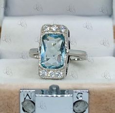 4.30 Ct Cushion Cut Aquamarine Vintage Art Deco Style Engagement Ring In 925 Sterling Silver Aqua Bezel Ring Art Deco Style Ring For WomenMain Stone Shape: CushionMain Stone Weight: 4.30CTMain Stone Colour: AquamarineMain Stone Type: Cubic ZirconiaPrimary Stone Shape: RoundPrimary Stone Colour: WhitePrimary Stone Type: Cubic ZirconiaMetal : Sterling SilverMetal Purity : 925Please contact us for Different Metal Color & Purity.✱ ETSY SHOP : https://www.etsy.com/in-en/shop/CreativeByChirag✱ Rea Art Deco Ring With Center Stone As Gift, Art Deco Ring With Center Stone For Gift, Art Deco Gia Certified Collectible Rings, Collectible Art Deco Gia Certified Rings, Aquamarine Diamond Ring With Vvs Clarity As Gift, Gia Certified Art Deco Sapphire Ring Gift, Art Deco Gia Certified Sapphire Ring As Gift, Vvs Clarity Aquamarine Diamond Ring As Gift, Gia Certified Sapphire Rectangular Ring