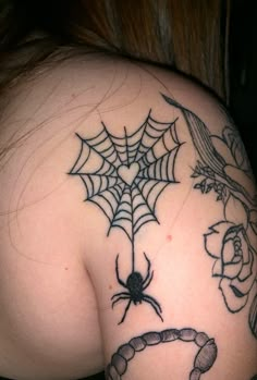 a woman with a spider web tattoo on her shoulder