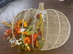 a pumpkin decorated with flowers and beads