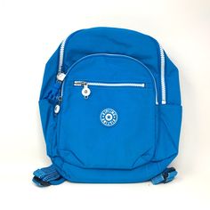 a small blue backpack sitting on top of a white floor