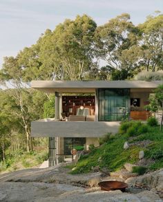 a modern house on the side of a hill