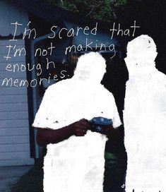 two people standing in front of a house covered in fake white towels with the caption i'm scared that i'm not making enough memories