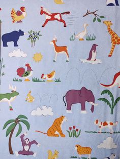 an elephant, giraffe and other animals on blue fabric