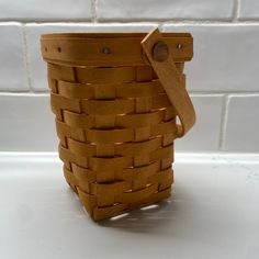 a wooden basket sitting on top of a white counter