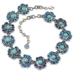 "Each link holds a curve of large glass turquoise beads accented with tiny collet set crystal and blue roses. The dozen links travel all the way around your neck to create a marvelous collar. Elements are cast in jeweler's metal and then layered in .925 silver. Size: 17\" L + 4\" extender, 1\" W Signed and copyrighted Ollipop, a division of Sweet Romance USA" Elegant Blue Turquoise Necklace, Elegant Blue Turquoise Necklace With Lobster Clasp, Unique Blue Turquoise Necklace, Blue Vintage Cabochon Jewelry, Vintage Blue Cabochon Jewelry, Unique Nickel-free Blue Turquoise Necklace, Blue Cabochon Metal Jewelry, Blue Metal Cabochon Jewelry, Vintage Turquoise Necklace For Jewelry Making