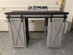 a desk made out of an old door and some sort of table with a sign on top